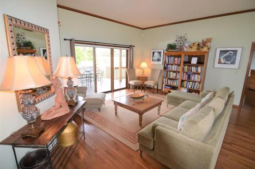 a living room with a couch and a table at Carraig Nua House in Fish Creek