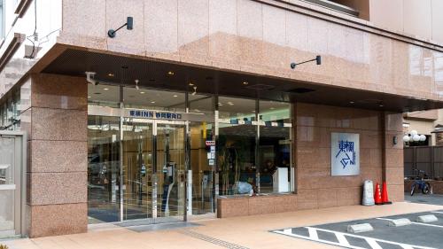 a store front of a building with glass windows at Toyoko Inn Shizuoka eki Minami guchi in Shizuoka