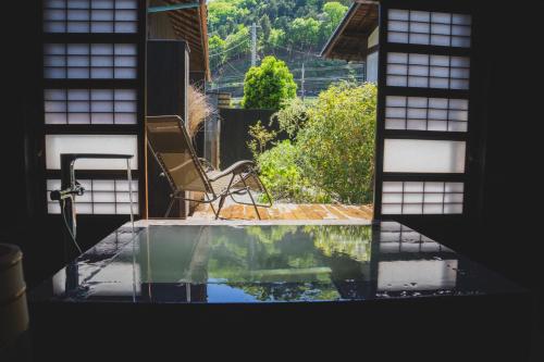 a view of a pool from a window of a house at Kominkayado LOOF Shikinoie in Ōtsuki