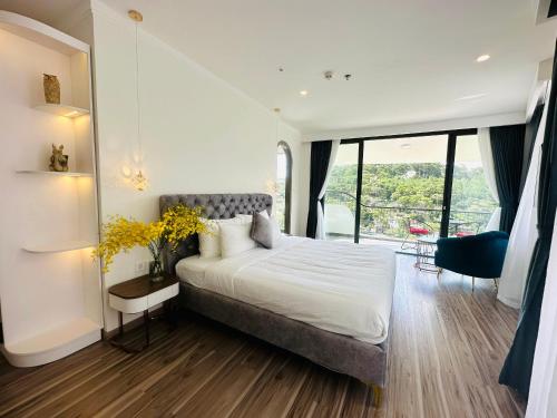 a bedroom with a bed and a large window at Memory Inn - Valley View in Xuan An