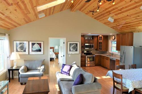 a kitchen and living room with a couch and a table at Carraig Dale Cottage in Fish Creek