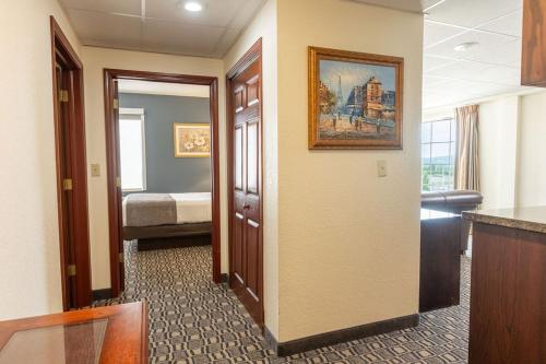 a corridor of a hotel room with a bedroom at Savannah House Hotel in Branson