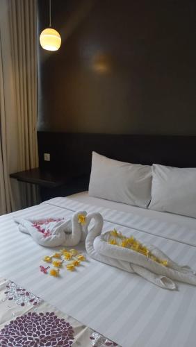 Ένα ή περισσότερα κρεβάτια σε δωμάτιο στο Cendana CoLiving Solo Baru