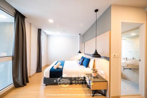 a bedroom with a king sized bed and a bathroom at Windmill Upon Hills Premium Suites Genting Highland in Genting Highlands