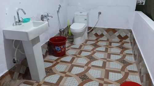 a bathroom with a sink and a toilet at DJSR Camp in Barkot