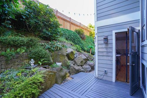 a wooden walkway leading to a house with a door at Sunlit contemporary Bellevue Home w a Lush Garden in Bellevue