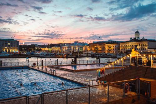 a view of a river with people in a swimming pool at Downtown Suite in Helsinki