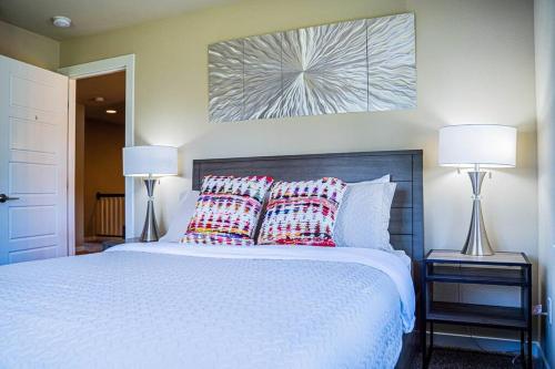 a bedroom with a white bed with pillows and two lamps at Kirkland Luxury Tranquil Retreat 7BR w Office in Kirkland