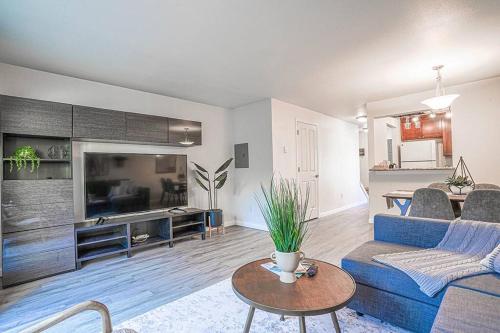 a living room with a blue couch and a table at Bellevue's townhome btw T-mobile & Microsoft HQ in Bellevue