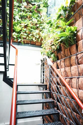 a staircase with plants on the side of a building at AMANGO HOSTEL in Ho Chi Minh City