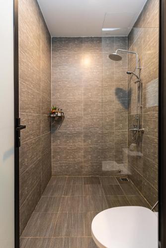 a bathroom with a shower with a tub and a sink at Hoianese Sunset Serenity Hotel in Hoi An