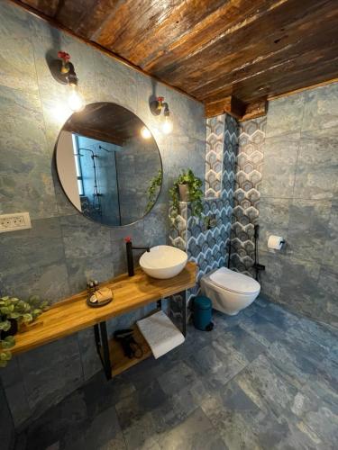 a bathroom with a sink and a mirror and a toilet at Tomis’ Dreams in Constanţa