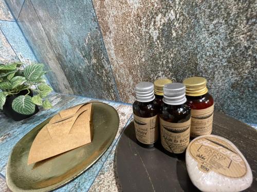 three bottles of honey on a table next to a hat at Tomis’ Dreams in Constanţa