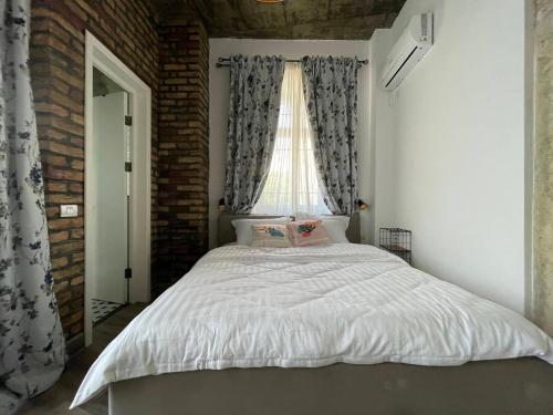 a bedroom with a large bed with a window at Tomis’ Dreams in Constanţa