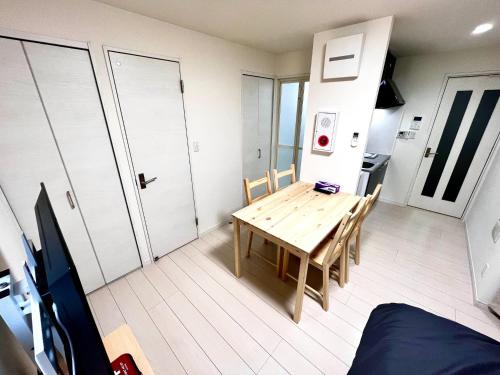 a small room with a wooden table and a kitchen at FL Residence Takadababa - Vacation STAY 9959 in Tokyo