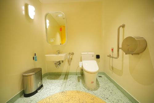 a bathroom with a toilet and a sink at GO Hotel Ban Chang at Robinson Lifestyle Ban Chang in Ban Chang