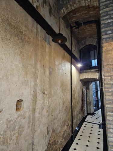 an alley way in an old building with a ceiling at Tomis’ Dreams in Constanţa