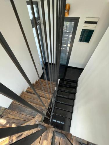 a spiral staircase in a house with wooden floors at Tomis’ Dreams in Constanţa