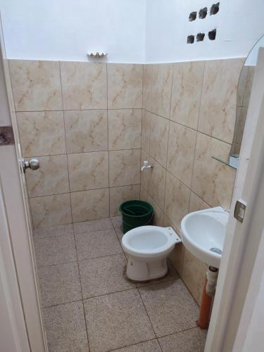 a bathroom with a toilet and a sink at Capul Beach Resort in Capul