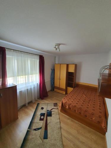 a bedroom with a bed and a dresser in it at Apartament vacanta in Mangalia