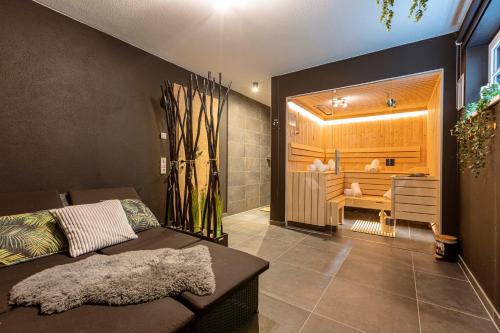 a bathroom with a bed and a tub in a room at Tauernlodges Uttendorf by ALPS RESORTS in Uttendorf