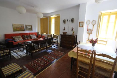 a living room with a couch and a table at QUINTA ARENlLLAS Palacete en una finca privada de 7 hectáreas de pinar in Navalperal de Pinares