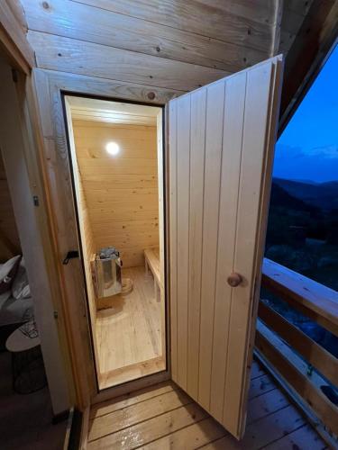 a small room with a door in a house at Sunset Lux Cottage Ravna Planina Pale - Jahorina in Pale