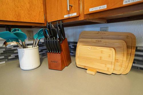 a kitchen counter with two wooden cutting boards and utensils at Waterfront Retreat, Relaxation, Fun in Hood Canal in Hoodsport