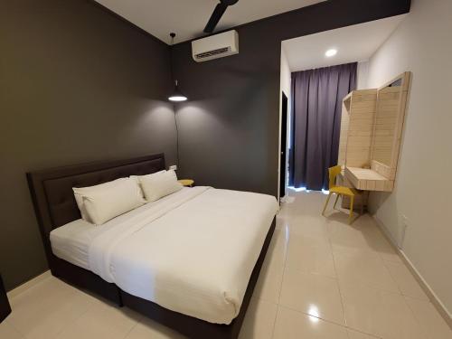 a bedroom with a large white bed and a window at Malacca City Center Town House by 360HOME in Melaka