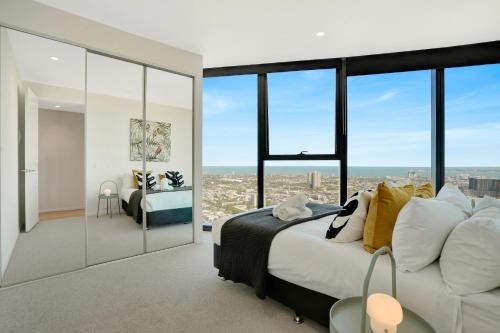 a bedroom with a bed and large windows at 3BR 2BATH, Southbank, Crown, Seaview, Level 41 in Melbourne