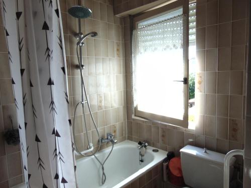 a bathroom with a shower and a tub and a sink at Maison dans un cadre de verdure in Saverne