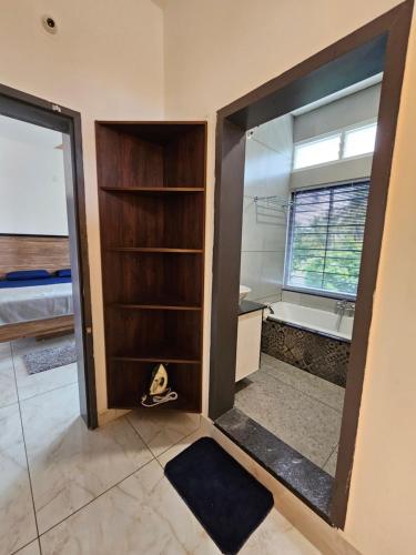 a bathroom with a mirror and a bath tub at Sambhrama Grand in Mysore