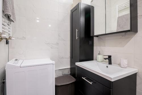 a white bathroom with a sink and a white counter at J&S Lux Central Suite 1 in Alexandroupoli
