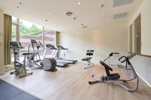 a gym with several exercise bikes and treadmills at Aspire Resort in Longtan