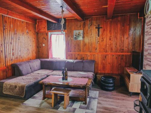 a living room with a couch and a table at Holiday Home Ljuban in Risovac