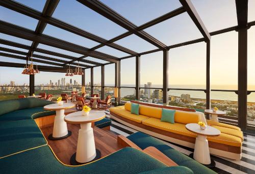 a view of a restaurant with tables and couches at Four Seasons Hotel Mumbai in Mumbai