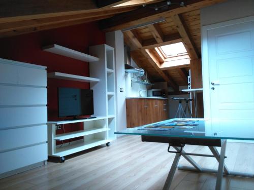 Habitación con TV y mesa. en ALDAJO Apartments, en Segovia