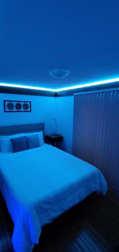 a bedroom with a bed with a blue light at New Seabury Retreat. Butchart Gardens' Inspired in Mashpee