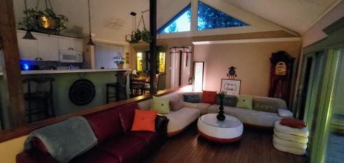 a living room with a couch and a table at New Seabury Retreat. Butchart Gardens' Inspired in Mashpee