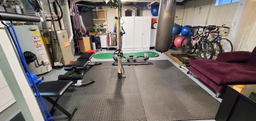 a garage with a gym with bikes and exercise equipment at New Seabury Retreat. Butchart Gardens' Inspired in Mashpee