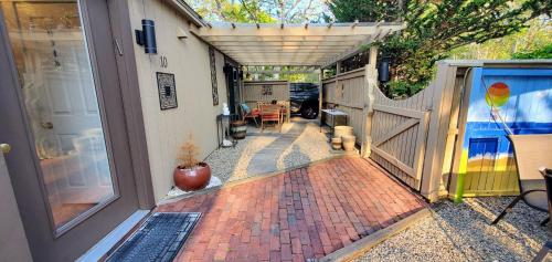 a house with an open door and a patio at New Seabury Retreat. Butchart Gardens' Inspired in Mashpee