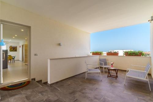 a room with a table and chairs and a large window at Le scuderie 7 in Galatone