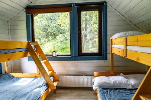 a room with two bunk beds and a window at Cabana Misha in Băişoara