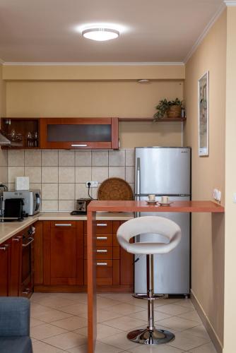 a kitchen with a bar with a stool in it at Pesti City Apartment&Free parking in Budapest