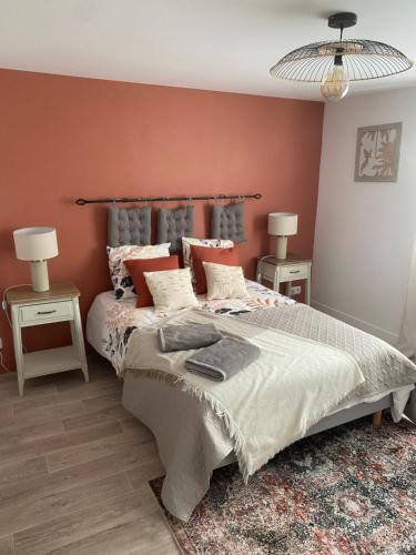 a bedroom with a large bed and two night stands at Logement de charme à Azay le Rideau in Cheillé