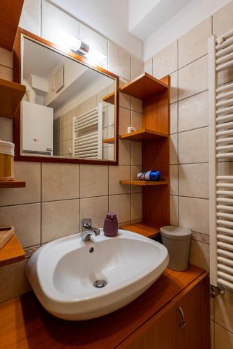 a bathroom with a sink and a mirror at Pesti City Apartment&Free parking in Budapest