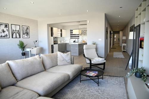 a living room with a couch and a kitchen at 2 Bedroom Luxury Apartment in Madliena Swieqi in Is-Swieqi