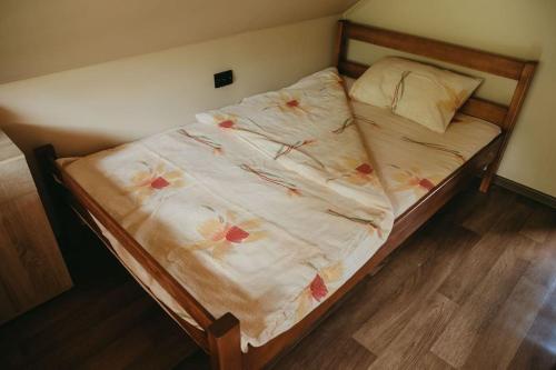 a bed with a floral bedspread on top of it at Etno Kutak Purtić in Ljubovija