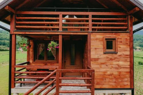 Cabaña de madera con una escalera que conduce a la puerta en Etno Kutak Purtić, en Ljubovija