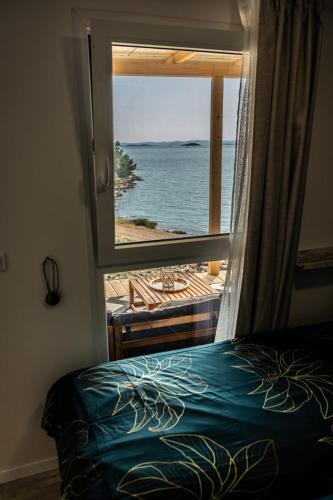 a bedroom with a window with a view of the ocean at La Vista in Drage